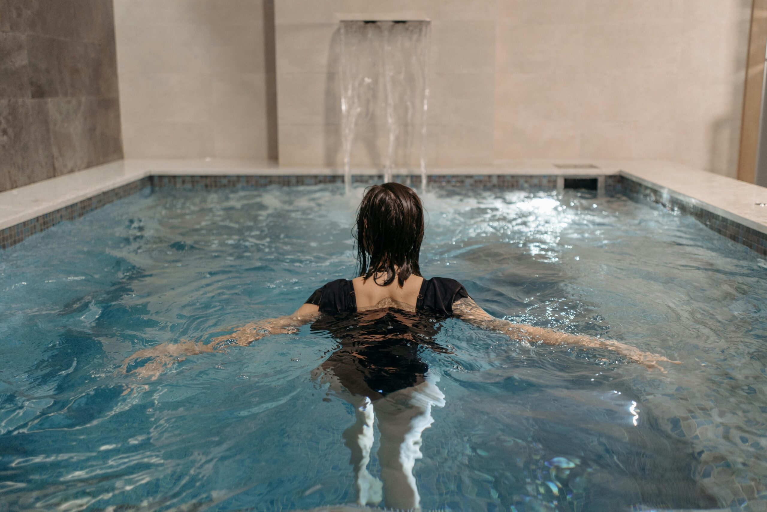 A lady in an indoor swimming pool at a hotel near kentucky exposition center