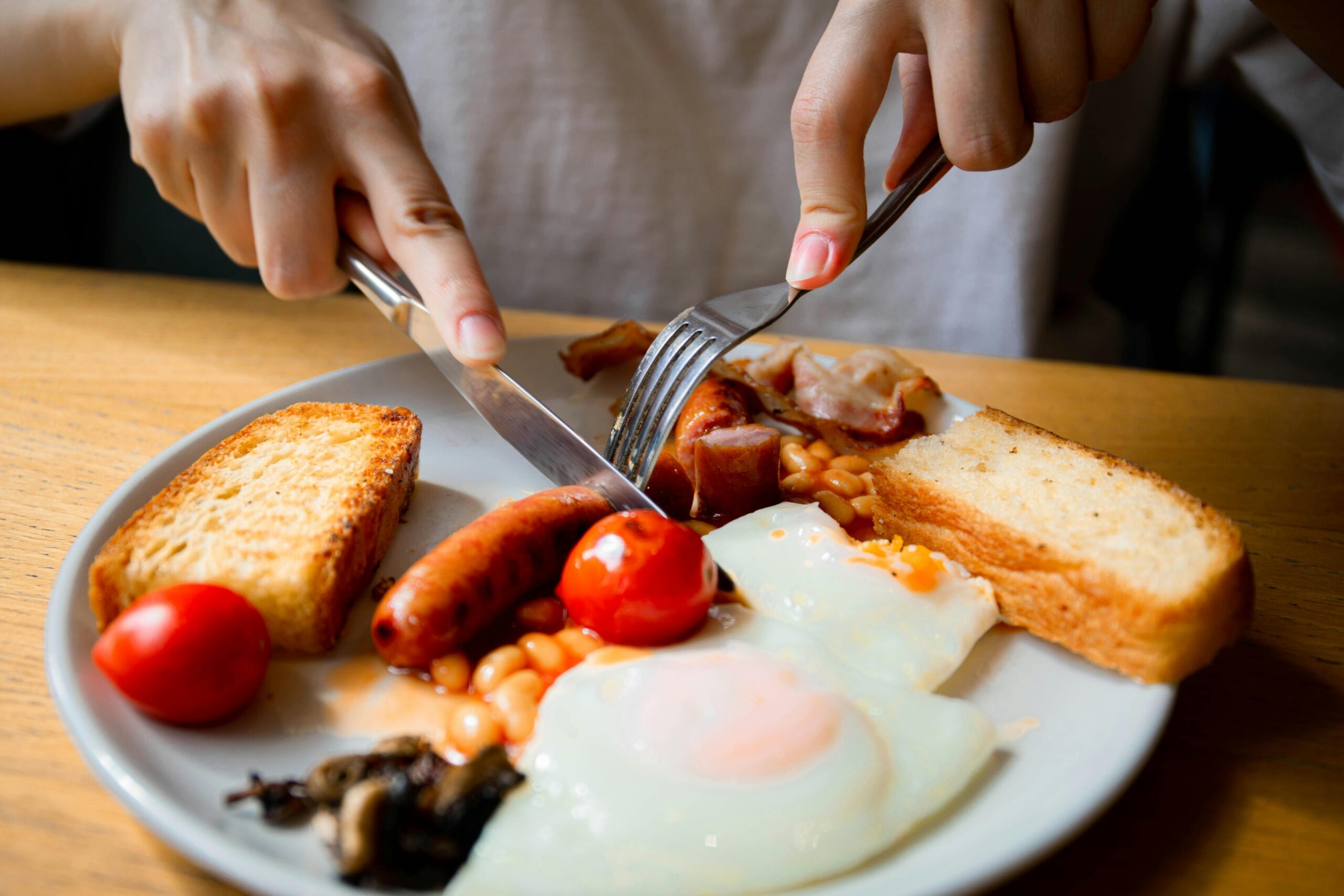 The image showcases a welcoming hotel lobby featuring a complimentary breakfast setup